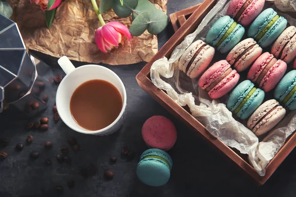 Flat lay composition with tasty macarons, cup of coffee and tulips on table — Stock Photo, Image