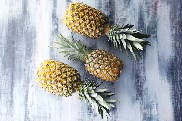 Tasty pineapples on wooden table — Stock Photo, Image