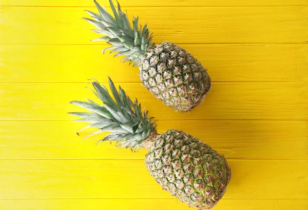 Tasty pineapples on wooden background — Stock Photo, Image