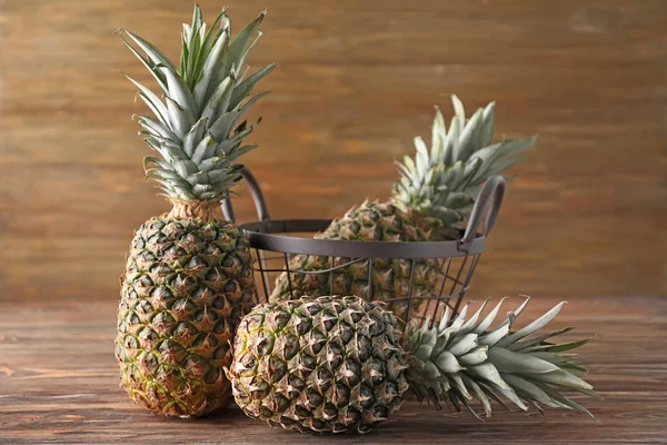 Tasty pineapples on wooden table — Stock Photo, Image