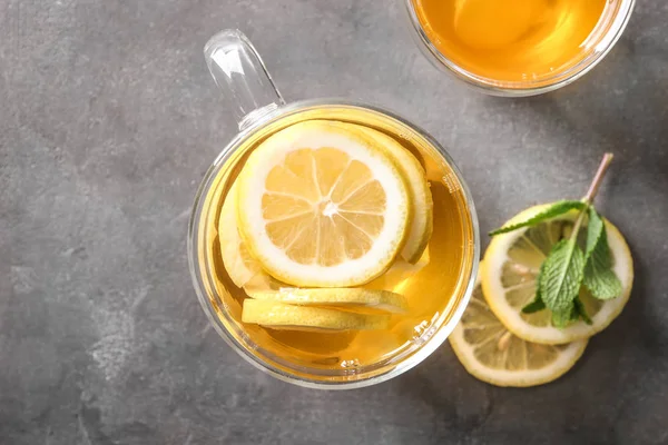 Glass cup of delicious tea with lemon on table — Stock Photo, Image