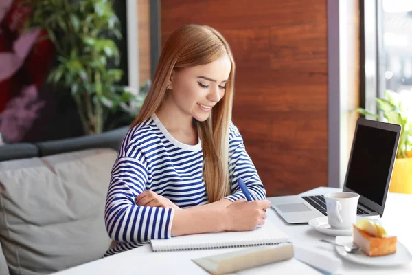 Mujer joven escribiendo carta en la mesa en la cafetería. Entrega de correo —  Fotos de Stock