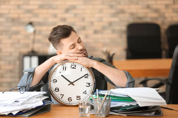 Müder Geschäftsmann mit Uhr im Büro. Zeitmanagement-Konzept — Stockfoto