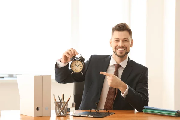 Businessman with alarm clock at table in office. Time management concept — Stock Photo, Image