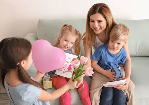 Mother receiving gifts from her cute little children at home — Stock Photo, Image