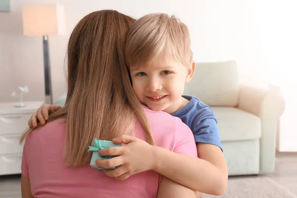 Mother receiving gift from her cute little son at home — Stock Photo, Image