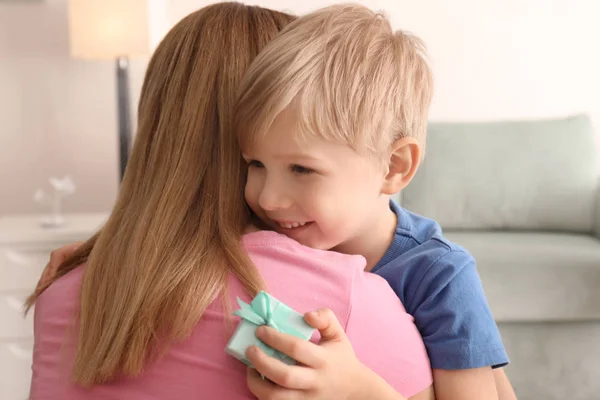 Mother receiving gift from her cute little son at home — Stock Photo, Image
