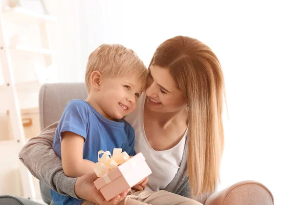 Mother receiving gift from her cute little son at home — Stock Photo, Image