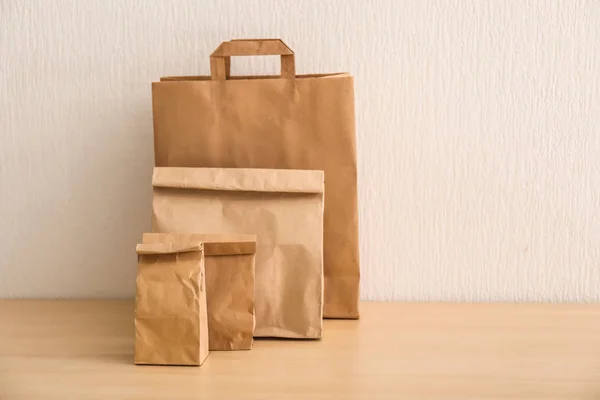 Different paper bags on light table. Food delivery service — Stock Photo, Image