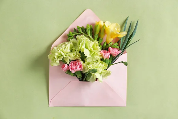 Open mail envelope with flowers on color background