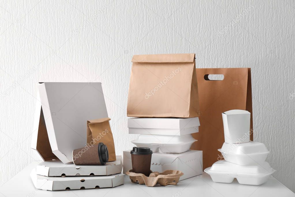 Assortment of food delivery containers on white table