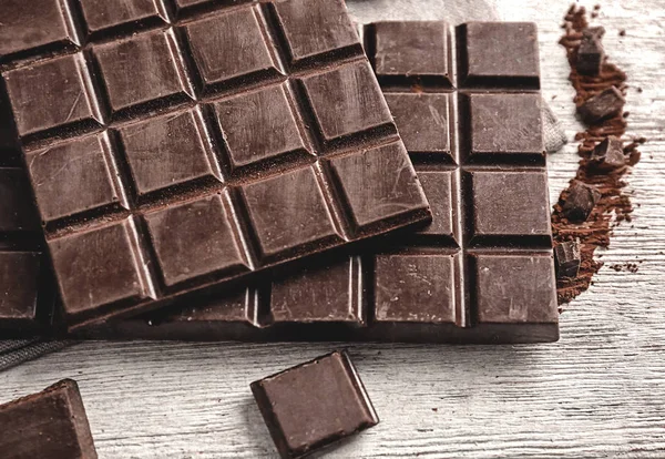 Yummy dark chocolate on wooden background — Stock Photo, Image