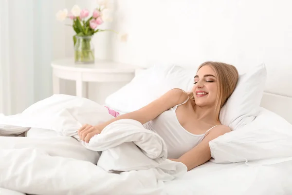 Young woman waking up in morning at home — Stock Photo, Image