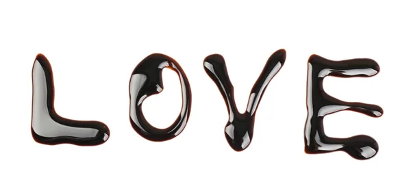 Wort Liebe geschrieben mit Schokoladensirup auf weißem Hintergrund — Stockfoto
