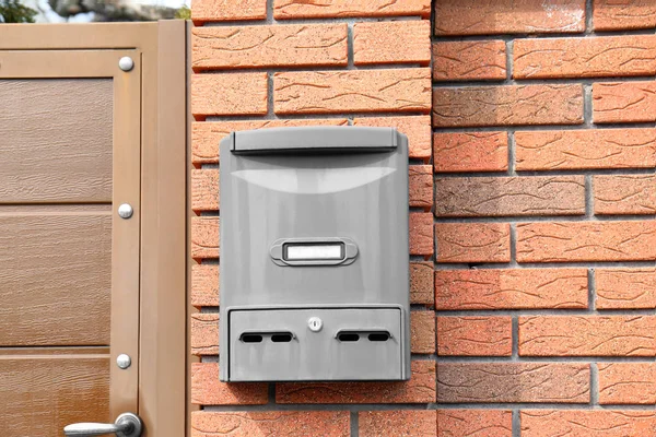 Modern mailbox on fence outdoors — Stock Photo, Image