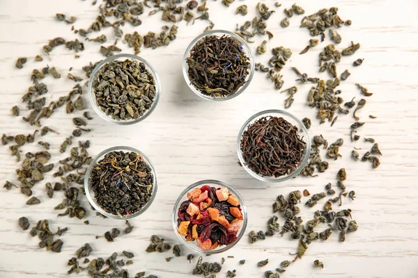 Variety of dry tea in glass bowls on table — Stock Photo, Image