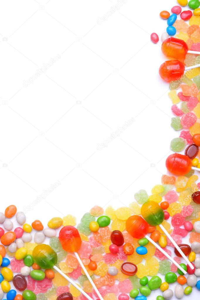 Tasty lollipops and colorful candies on white background