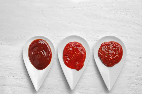 Delicious barbecue sauces in bowls on table, top view — Stock Photo, Image