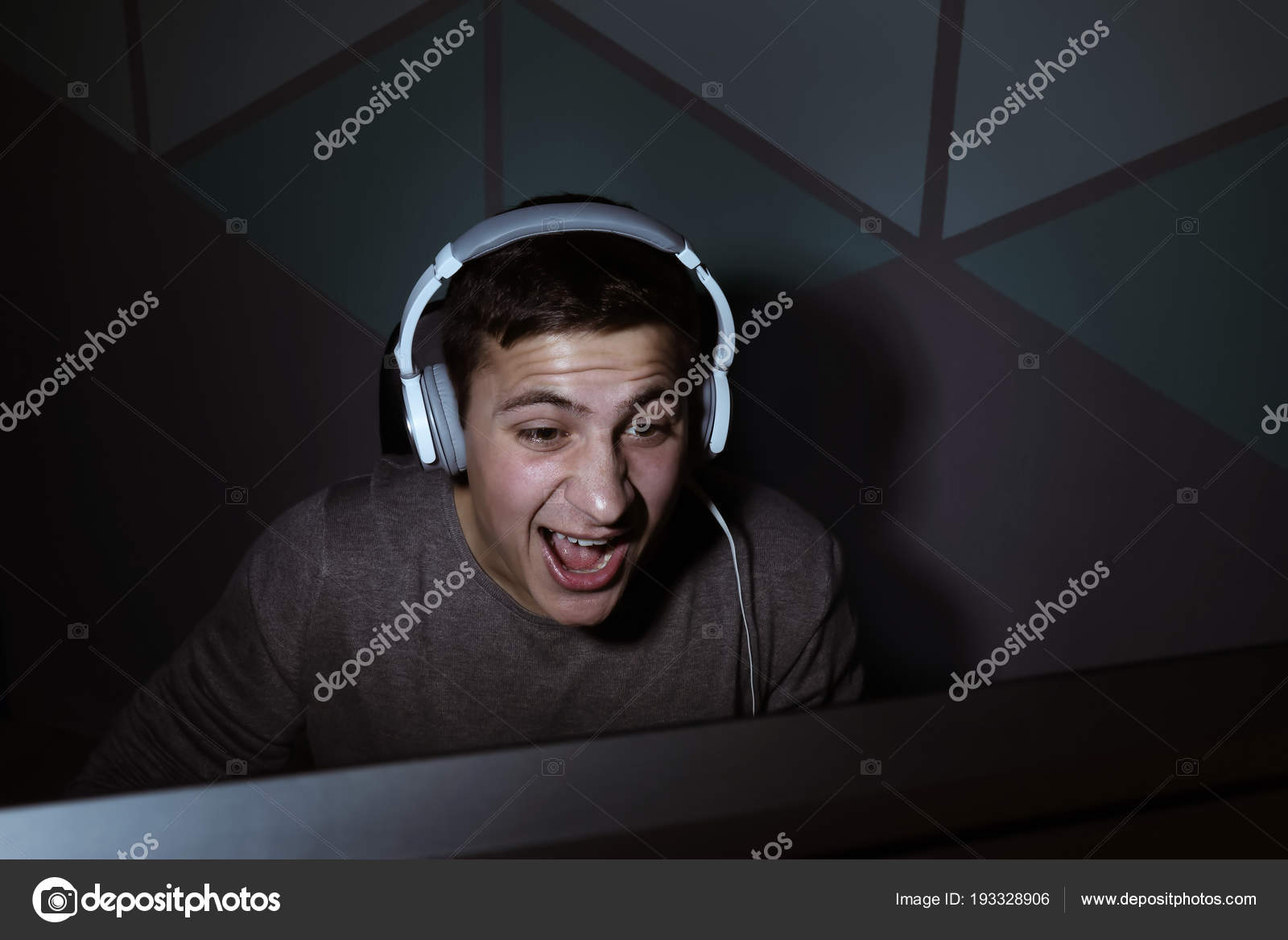 young-man-playing-video-games-at-home-in-darkness-stock-photo-by