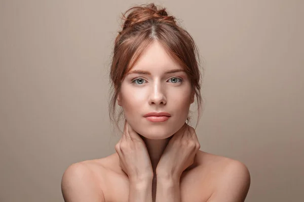 Beautiful young woman with silky skin on grey background — Stock Photo, Image