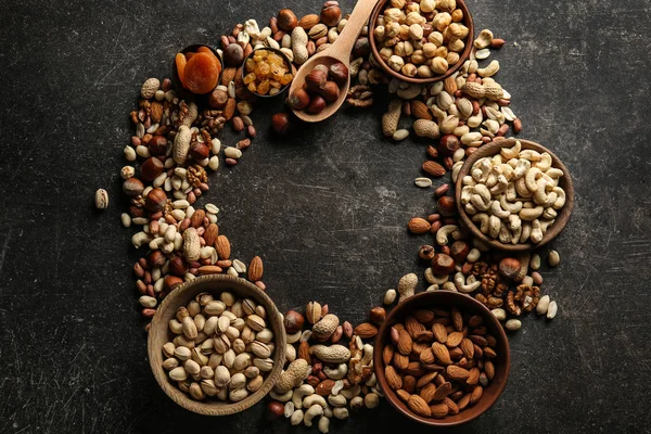 Frame made of different nuts on grey background — Stock Photo, Image