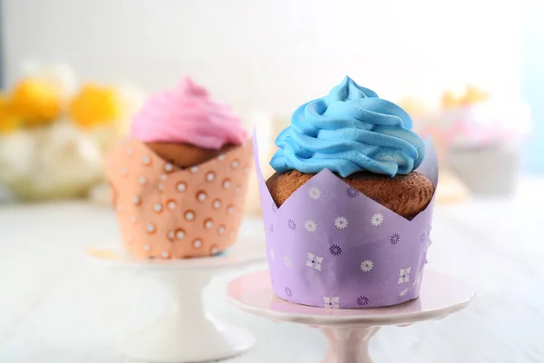 Stands with tasty cupcakes on table. Mother's Day celebration — Stock Photo, Image