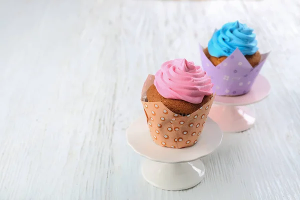 Stands with tasty cupcakes on table. Mother's Day celebration — Stock Photo, Image