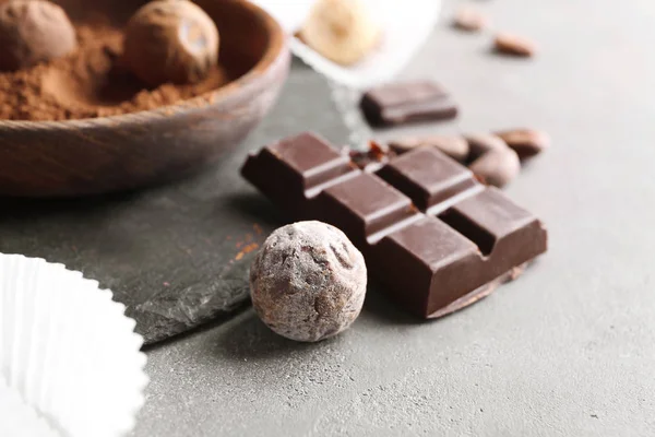 Chocolate candy and piece of bar on table — Stock Photo, Image