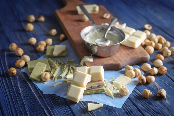 Composition with melted white chocolate on wooden table