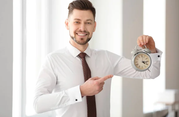 Businessman with alarm clock in office. Time management concept — Stock Photo, Image