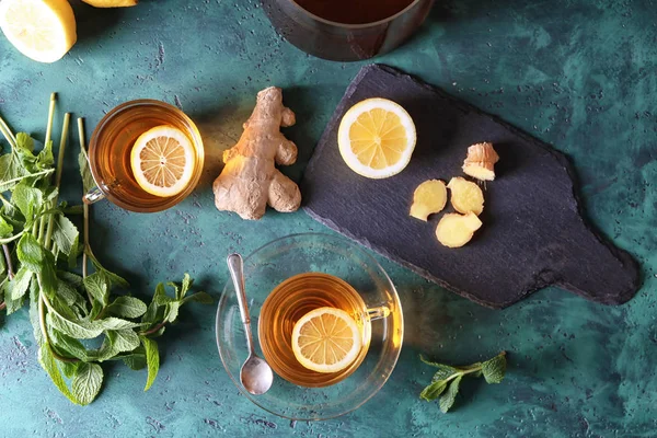 Cups of hot tea with ginger and lemon on table — Stock Photo, Image