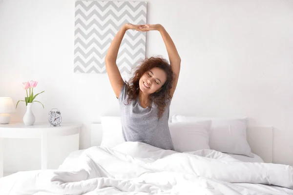 Morning of young African-American woman in bedroom — Stock Photo, Image