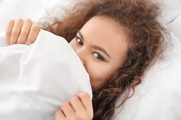 Morning of young African-American woman in bed — Stock Photo, Image