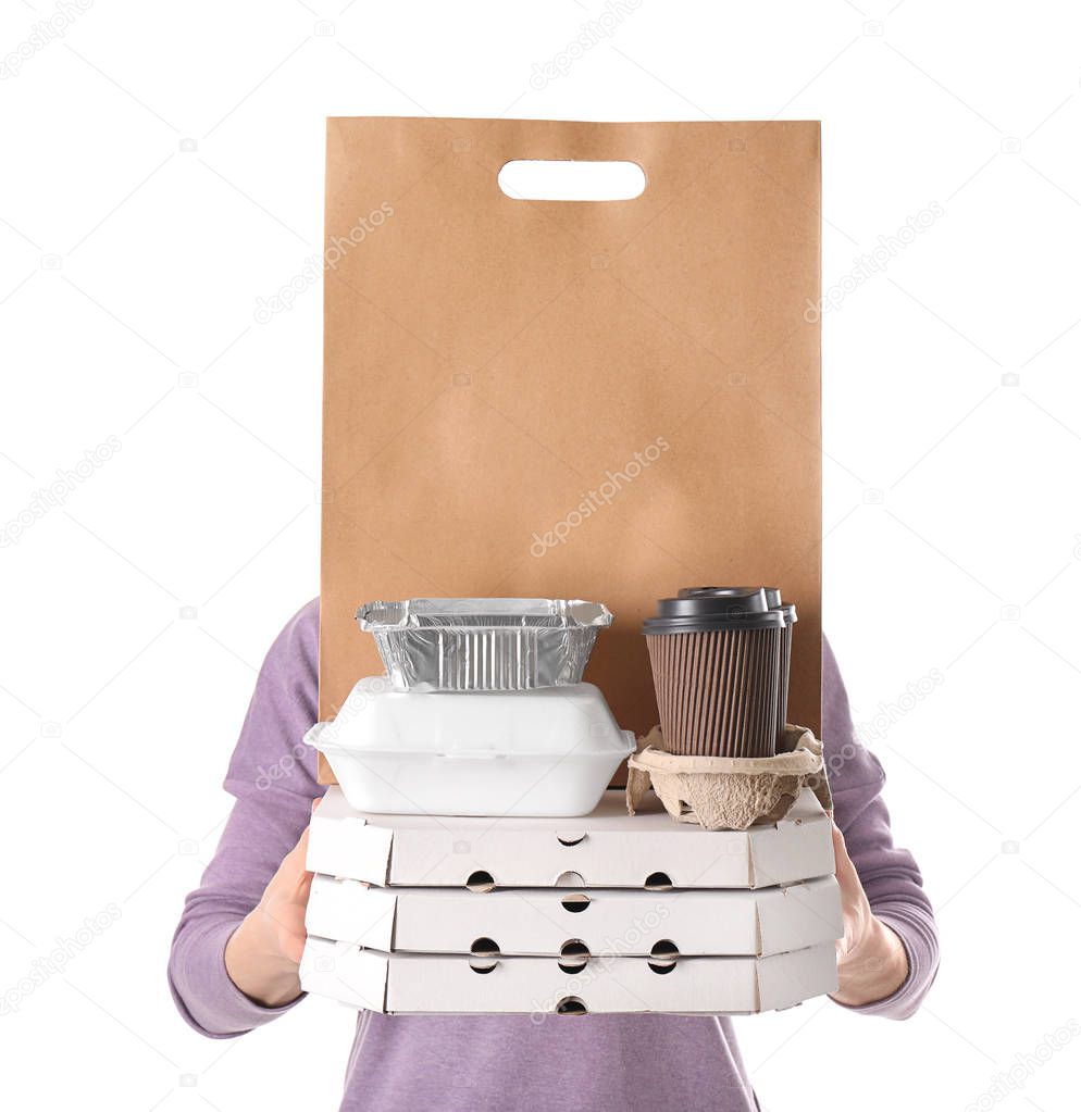 Woman with products in paper bag and containers on white background. Food delivery service