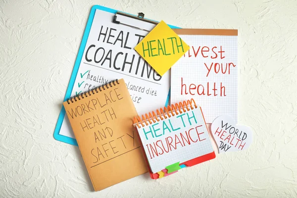 Inscriptions about health written in notebooks on white textured background — Stock Photo, Image