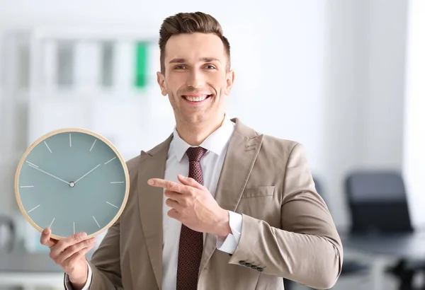 Successful businessman with clock in office. Time management concept — Stock Photo, Image