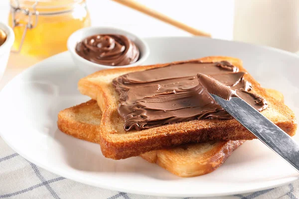Delicious toasts with chocolate paste on plate — Stock Photo, Image