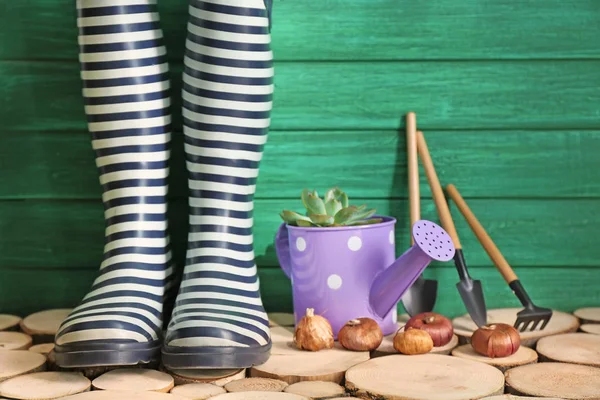Composition with rubber boots for gardening on wooden background — Stock Photo, Image