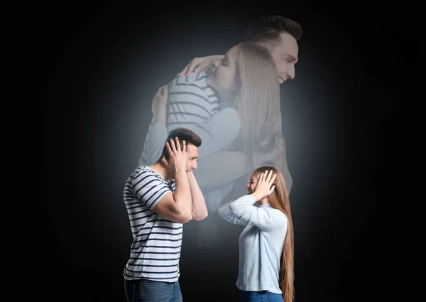 Quarreling young couple dreaming about making peace on dark background — Stock Photo, Image