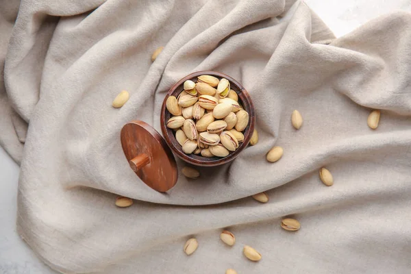 Jar with tasty pistachio nuts on table — Stock Photo, Image