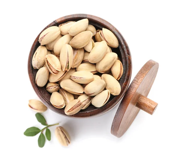 Jar with tasty pistachio nuts on white background — Stock Photo, Image