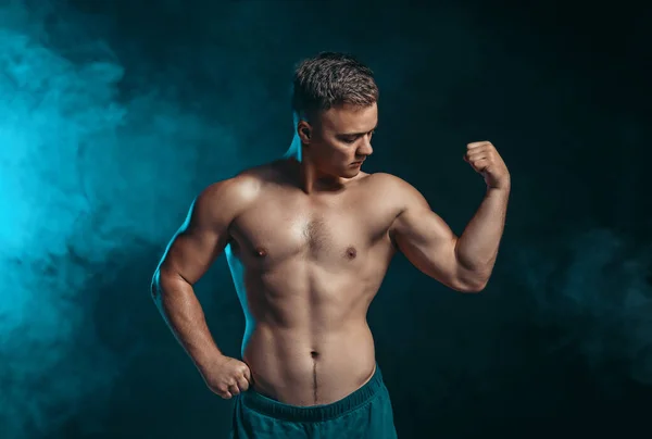 Handsome male bodybuilder on dark background — Stock Photo, Image