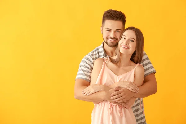 Portrait de jeune couple heureux sur fond de couleur — Photo