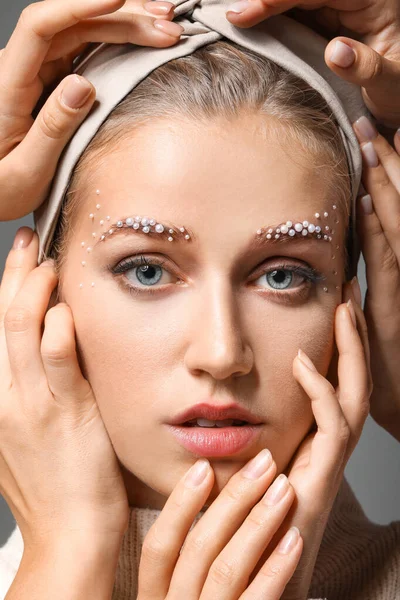 Portrait of young woman with creative eyebrows and many hands — Stock Photo, Image