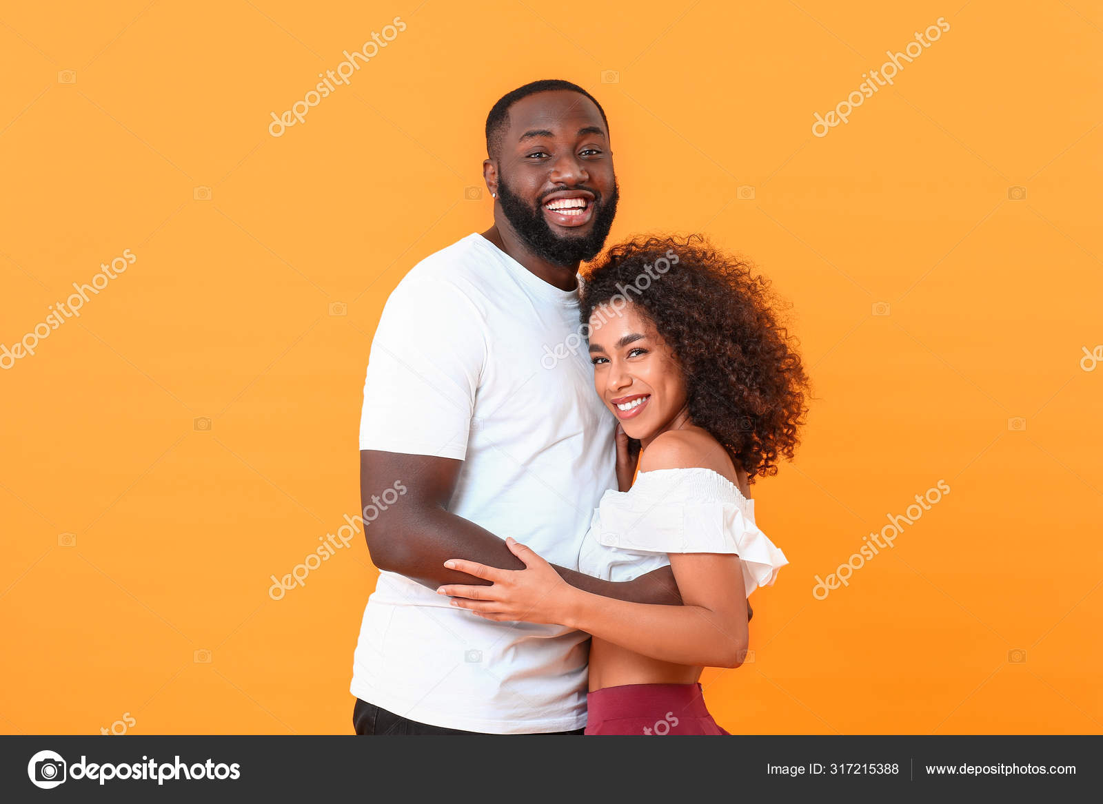 Portrait of happy African-American couple on color background Stock