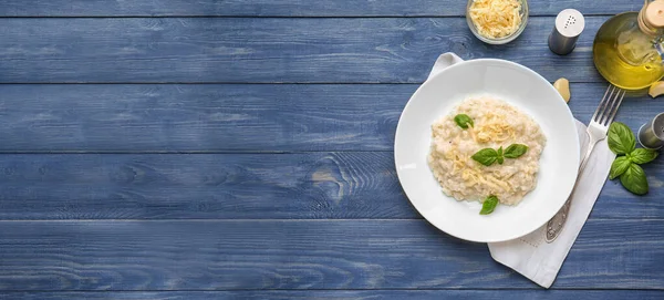 Plate with tasty risotto on wooden table with space for text — Stock Photo, Image