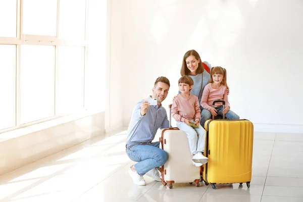 Happy family with luggage taking selfie in airport — Stock Photo, Image