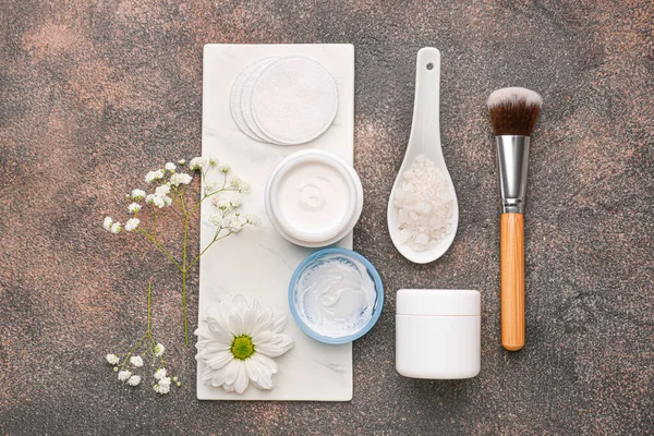 Cosmetic creams with sea salt and brush on grey background — Stock Photo, Image
