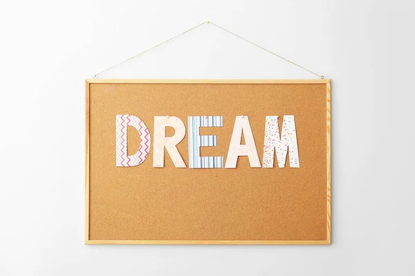 Board with word DREAM on white background — Stock Photo, Image
