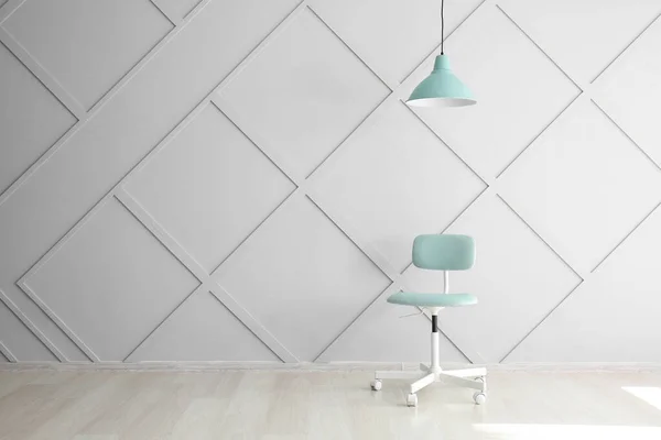 Stylish chair with lamp near grey wall — Stock Photo, Image